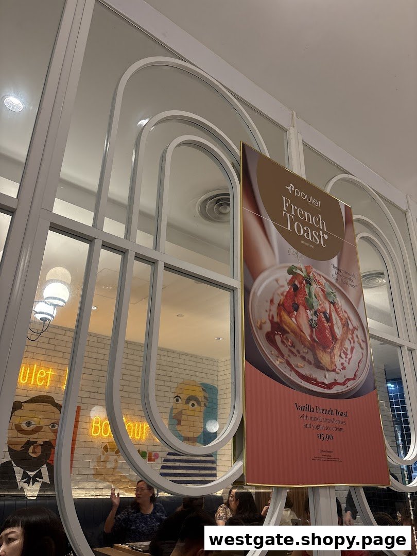An interior view of Poulet restaurant featuring a promotional poster for Vanilla French Toast and customers dining.