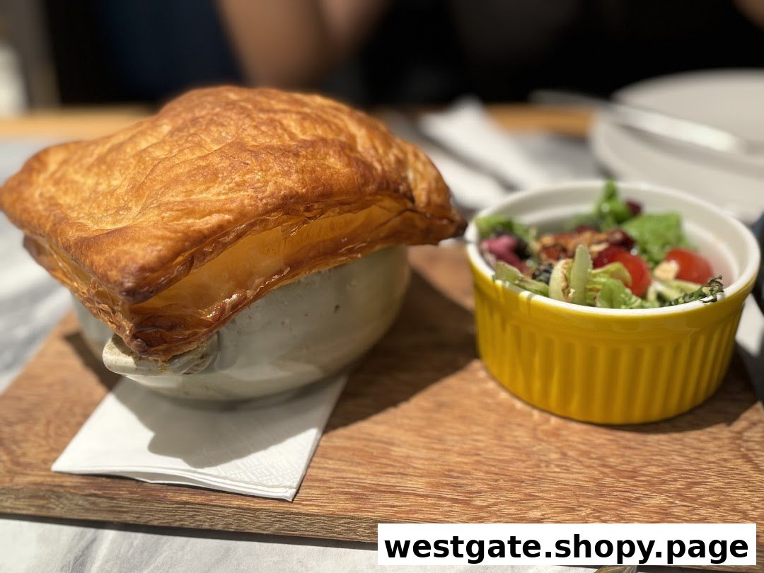 A golden-crusted pot pie and fresh side salad served on a wooden board.