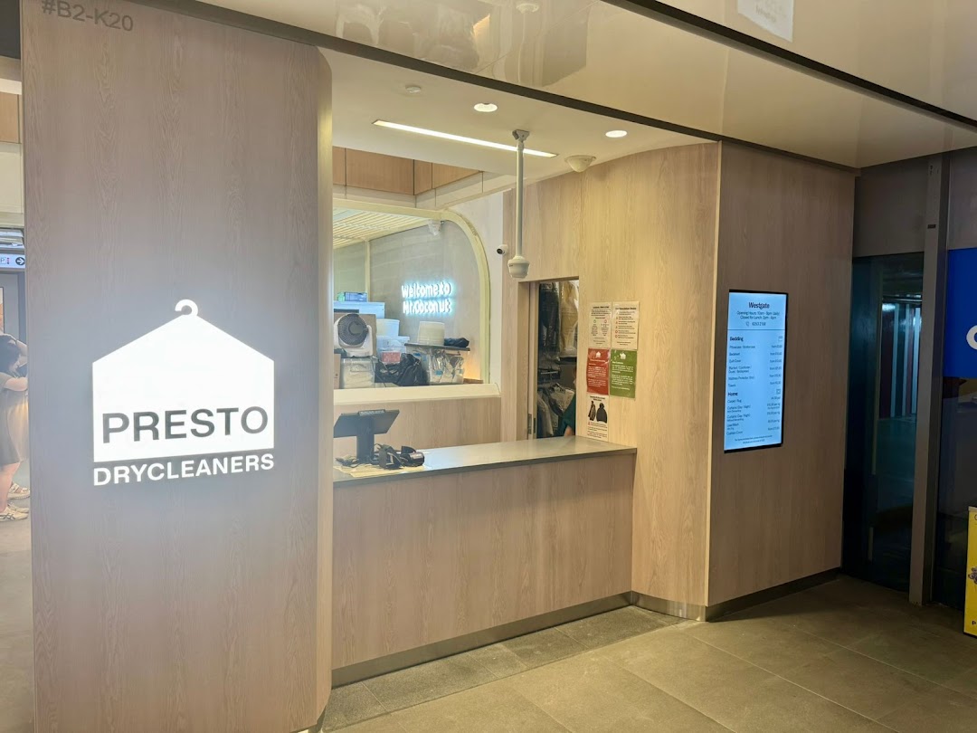 The modern and clean shop front of Presto Drycleaners, featuring its prominent logo and service counter.