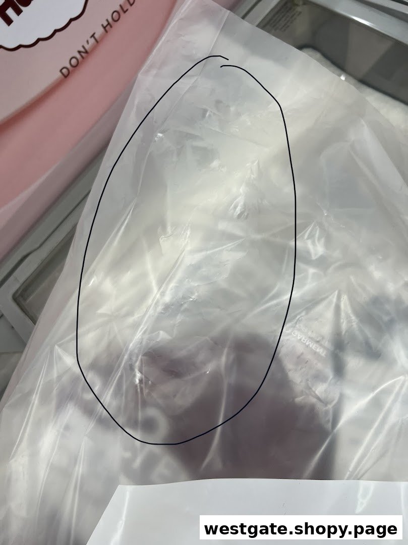 Close-up of dry-cleaned garments neatly packaged in a clear plastic bag.