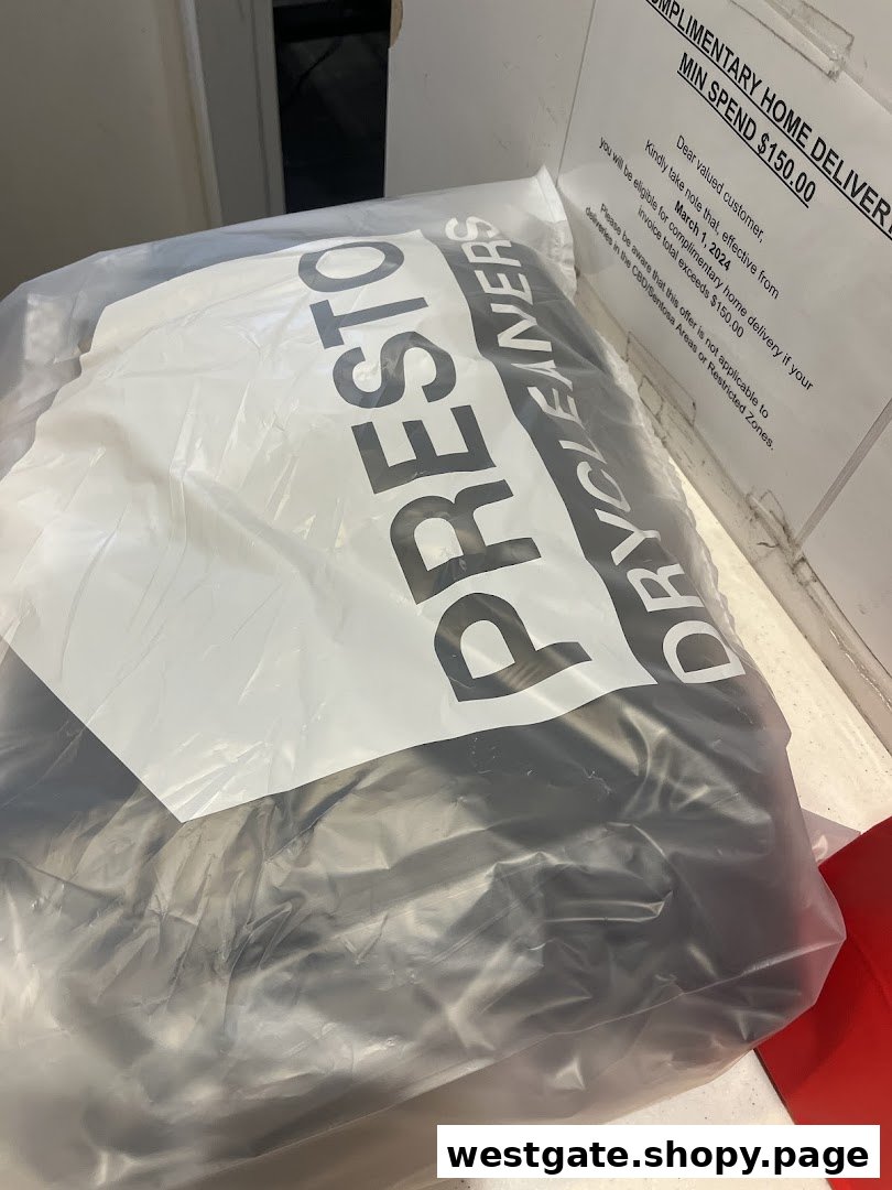 A plastic bag from Presto Drycleaners with a sign detailing a complimentary home delivery offer.
