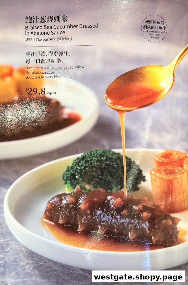A close-up of Braised Sea Cucumber with Abalone Sauce, showing a spoon pouring sauce over the dish.
