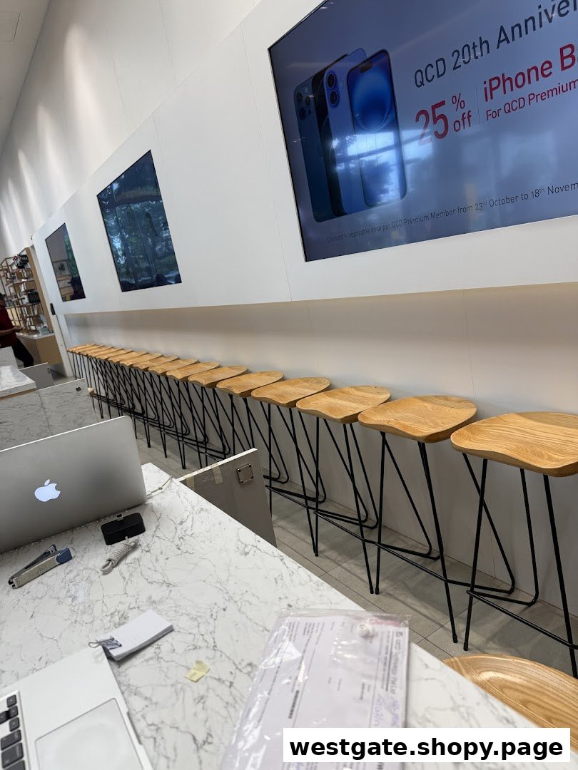 Interior of QCD Technology, an Apple Authorised Service Provider, featuring a service counter and customer seating.
