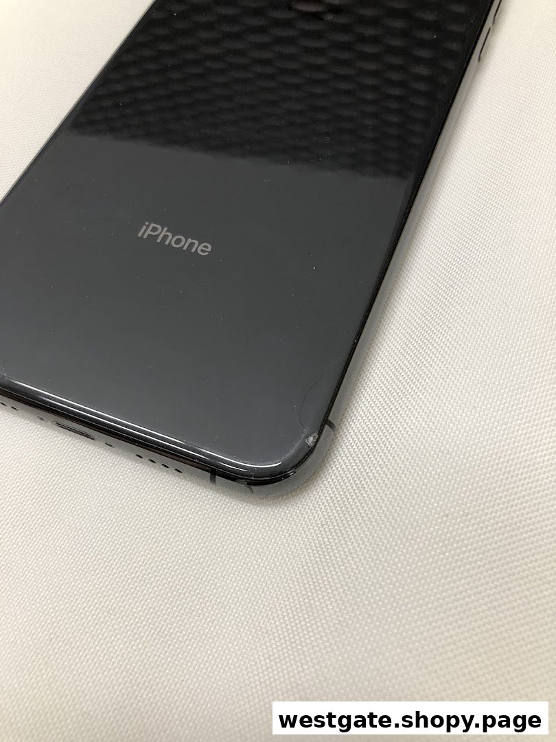Close-up of the back of a black iPhone showing the logo and a minor chip.