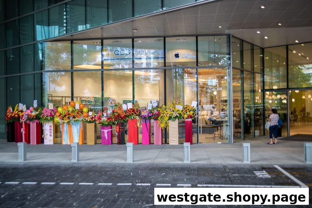 The shop front of QCD Technology, an Apple Authorised Service Provider, adorned with numerous floral arrangements.