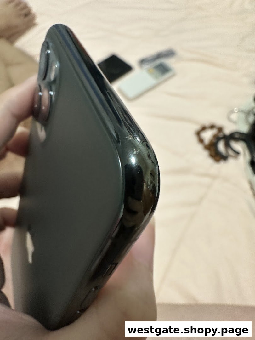 Close-up of a damaged iPhone, highlighting a chipped corner and side.