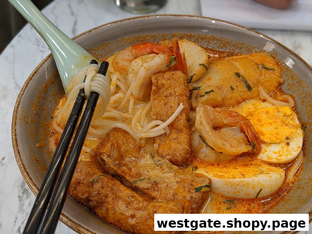A vibrant bowl of spicy noodles with prawns, eggs, and tofu puffs, ready to be enjoyed.