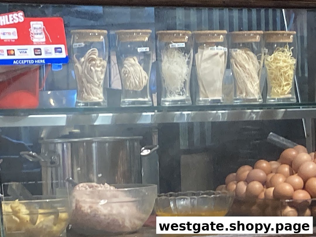 Various fresh noodles, eggs, and ingredients displayed behind the counter at Qiu Lian Ban Mian.