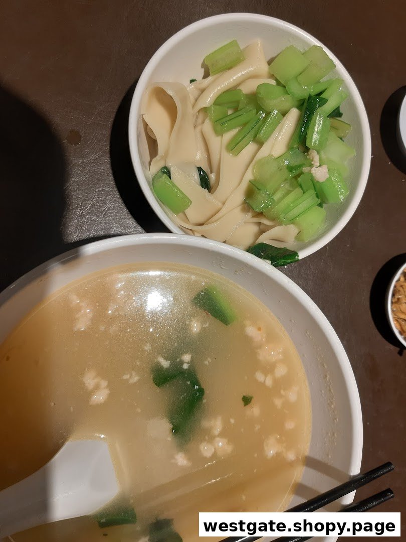 Two bowls of traditional Ban Mian, one with noodles and greens, the other with a rich broth.