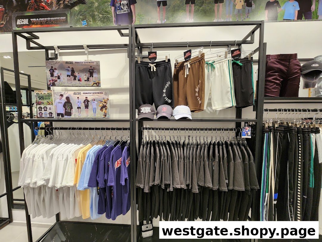 Interior view of RECOIL clothing store featuring trendy apparel, t-shirts, shorts, and a Transformers collaboration display.