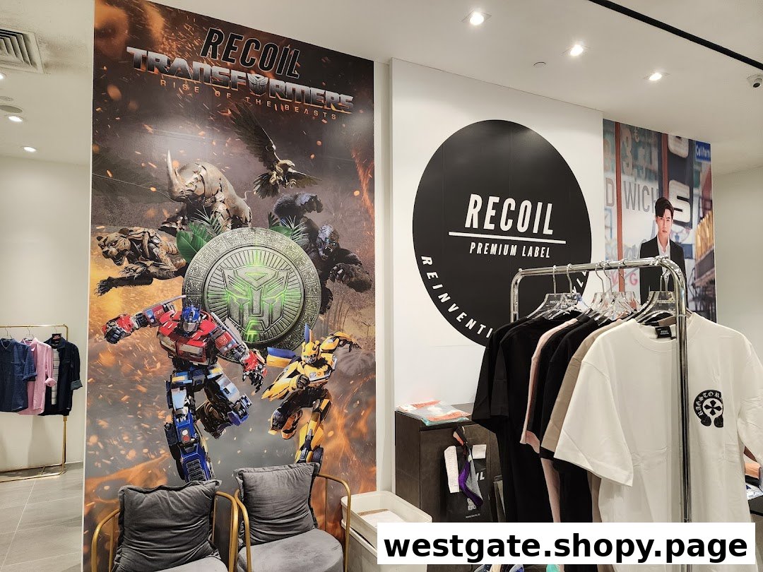 Interior of RECOIL shop with Transformers poster, clothing rack, and brand signage.
