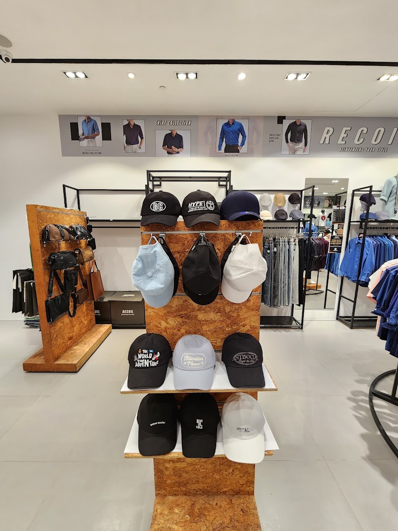 Interior view of RECOIL clothing store showcasing a wide selection of stylish hats and apparel on display.