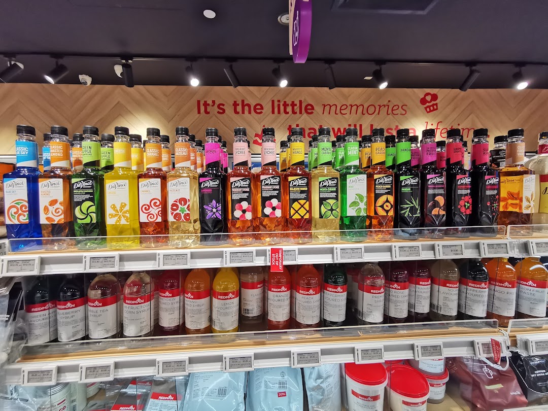 Shelves at RedMan by Phoon Huat displaying a wide array of DaVinci Gourmet and RedMan brand syrups and baking ingredients.