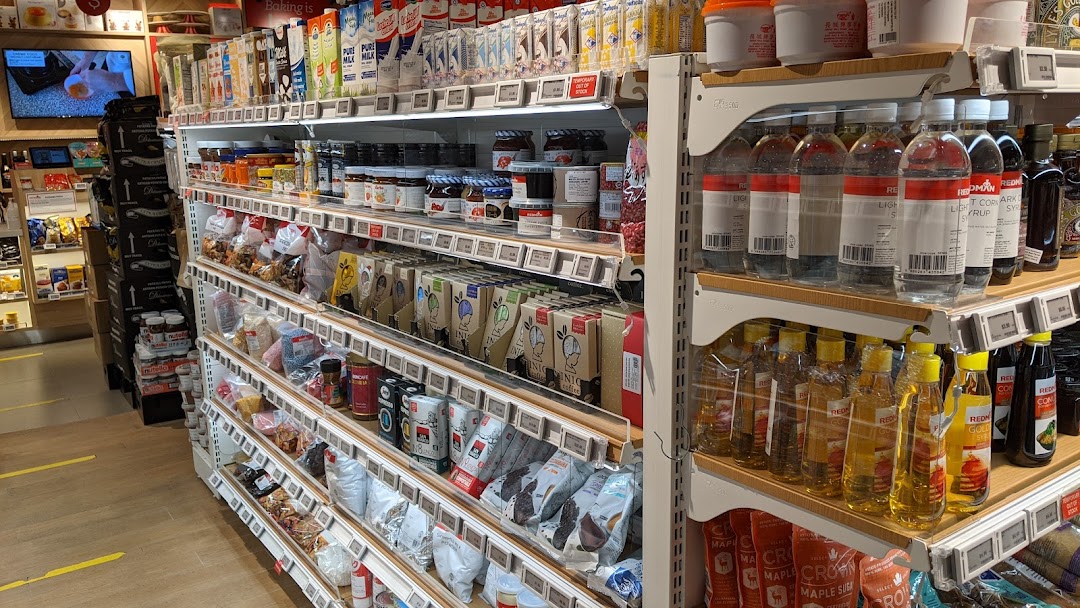 An interior view of RedMan by Phoon Huat, showcasing shelves stocked with baking ingredients and food products.