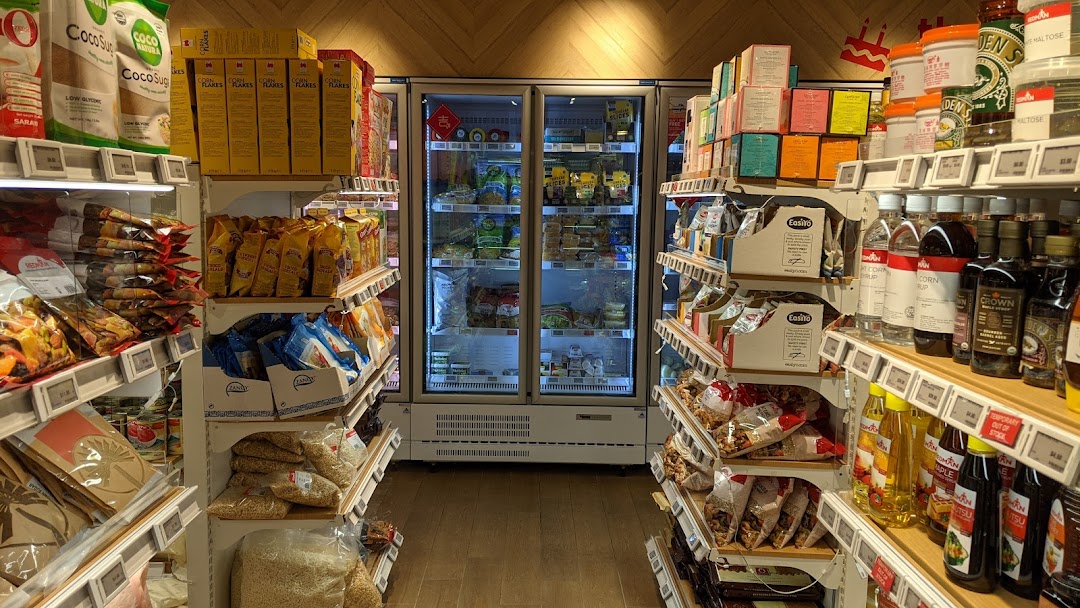 An interior view of RedMan by Phoon Huat, showcasing aisles stocked with baking ingredients and refrigerated items.
