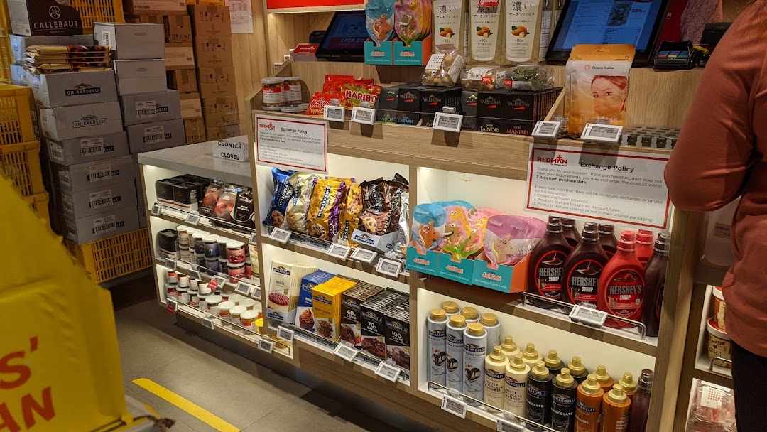 An interior view of RedMan by Phoon Huat, showcasing shelves stocked with baking ingredients, chocolates, and confectionery.