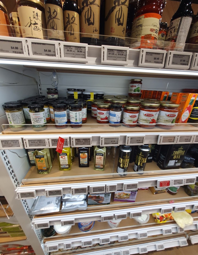 Shelves stocked with a variety of gourmet sauces, oils, and cooking ingredients at RedMan by Phoon Huat.