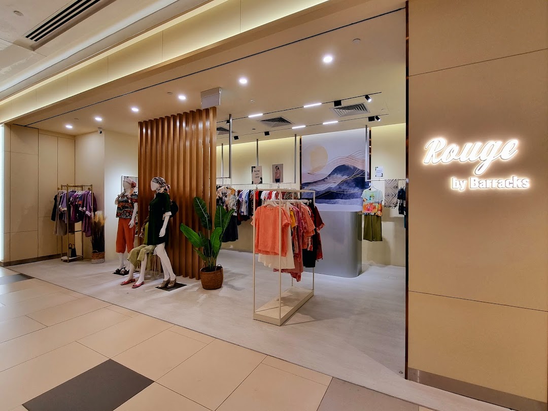 The inviting shop front of Rouge by Barracks, showcasing stylish apparel on mannequins and racks.