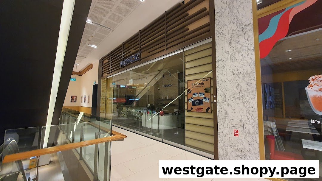 The elegant storefront of Royce', a premium chocolate shop, located within a modern shopping mall.