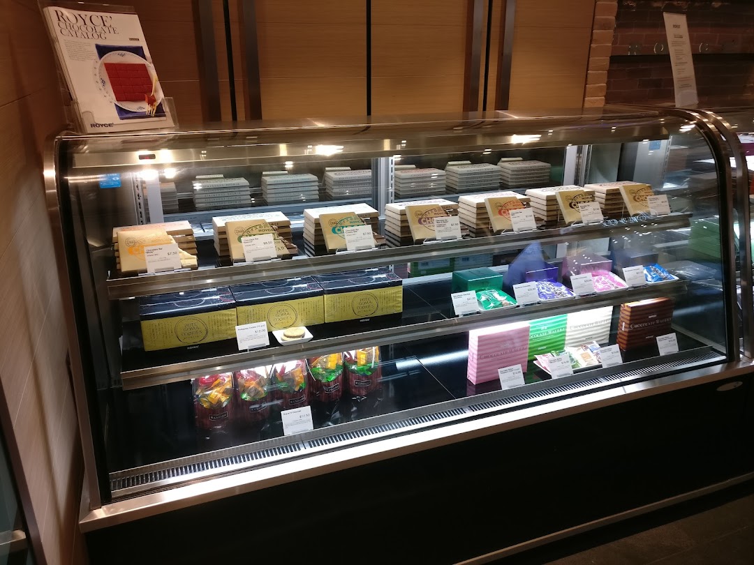 A well-lit display case showcasing a variety of Royce chocolates and confections.