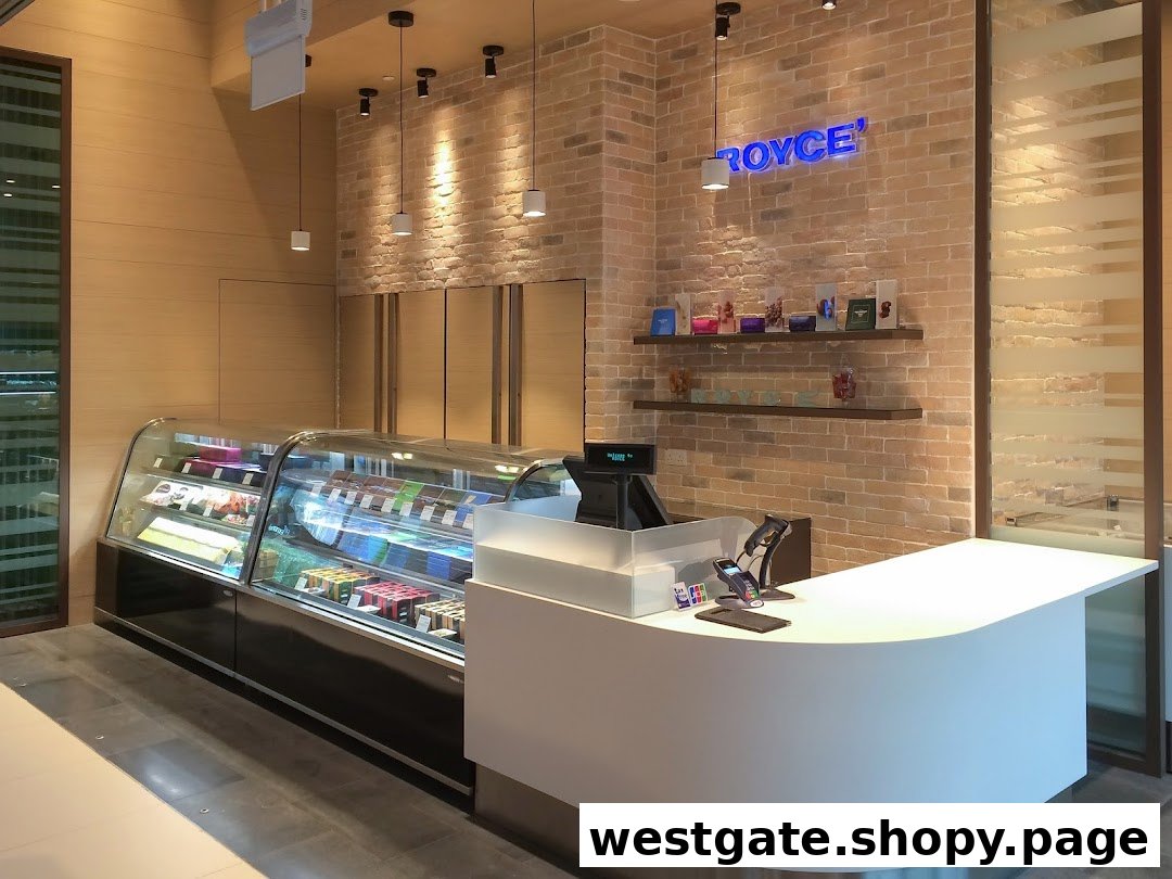 Interior view of Royce' chocolate shop featuring a display case, modern counter, and brick wall with branding.
