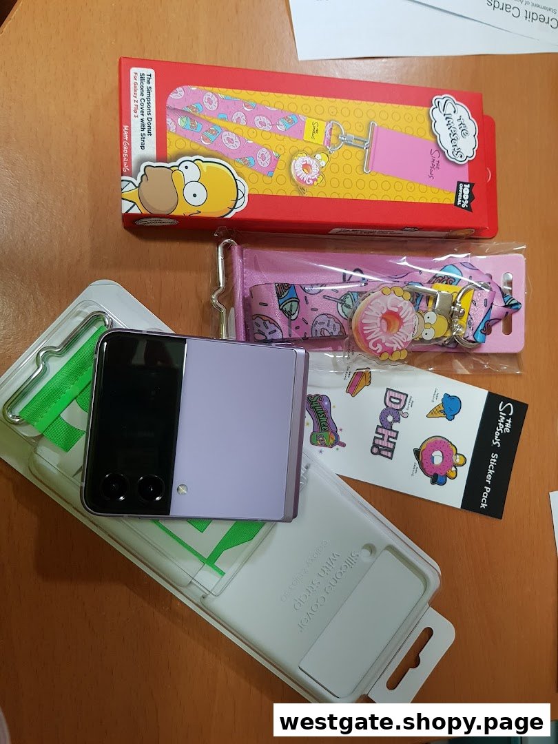 A purple Samsung Galaxy Z Flip phone, a silicone cover, and Simpsons-themed accessories are displayed.