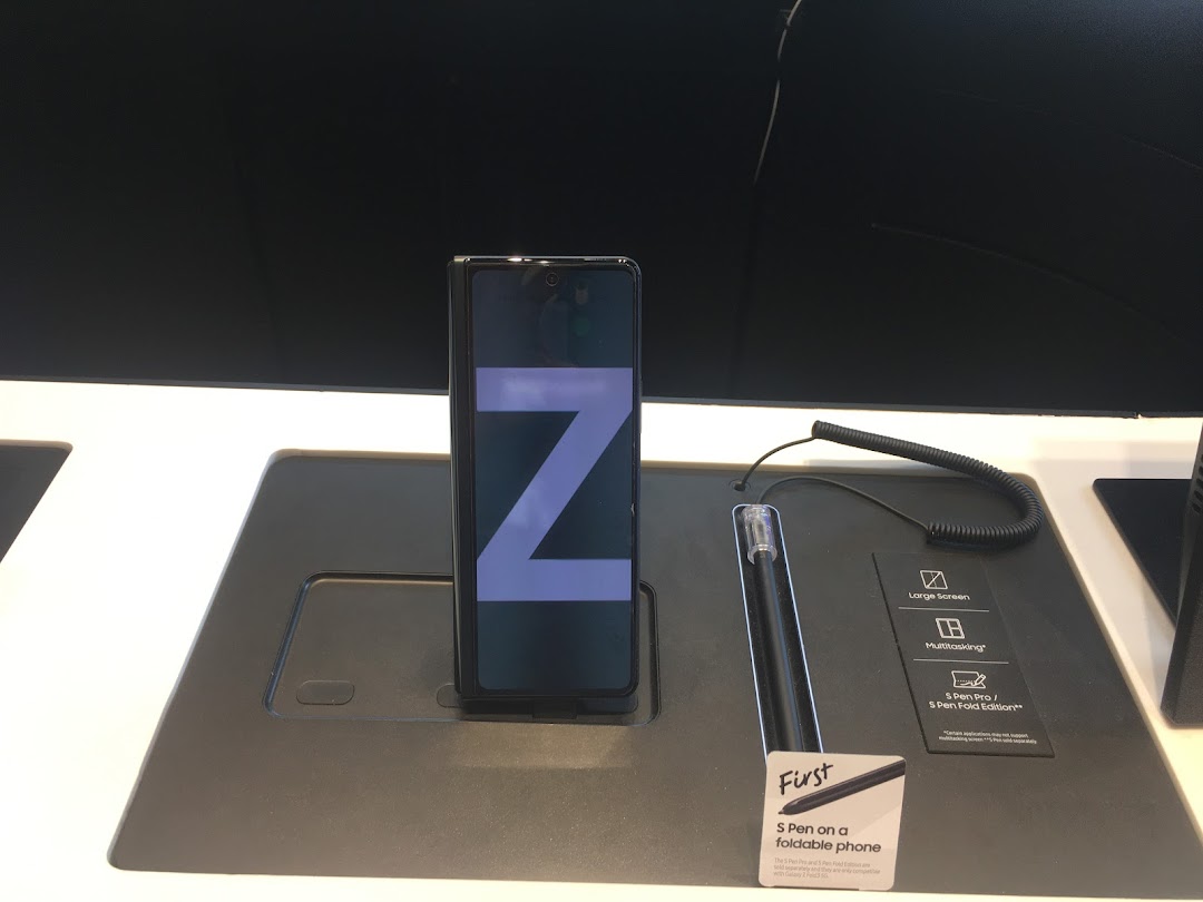 A Samsung foldable phone (Z Fold) and S Pen on display, highlighting large screen, multitasking, and S Pen compatibility.
