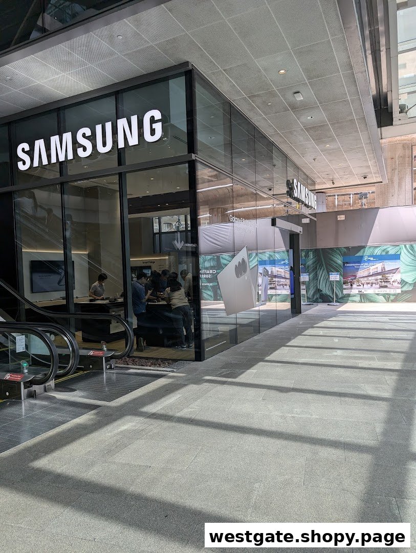 The modern glass facade of a Samsung Experience Store, showcasing its entrance and interior with customers.