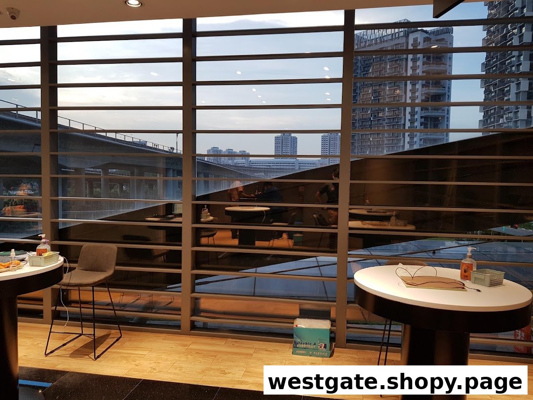 Interior view of a service centre with modern tables, chairs, and a large window overlooking the city.
