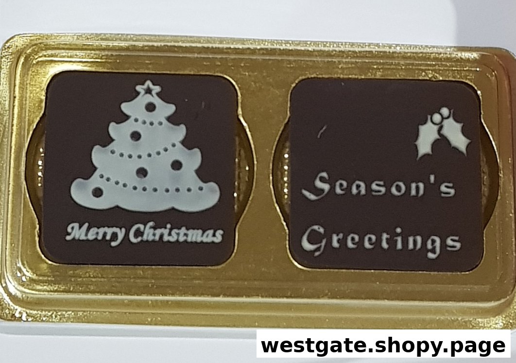 Two festive chocolates in a gold tray, one with a Christmas tree, the other with 'Season's Greetings'.