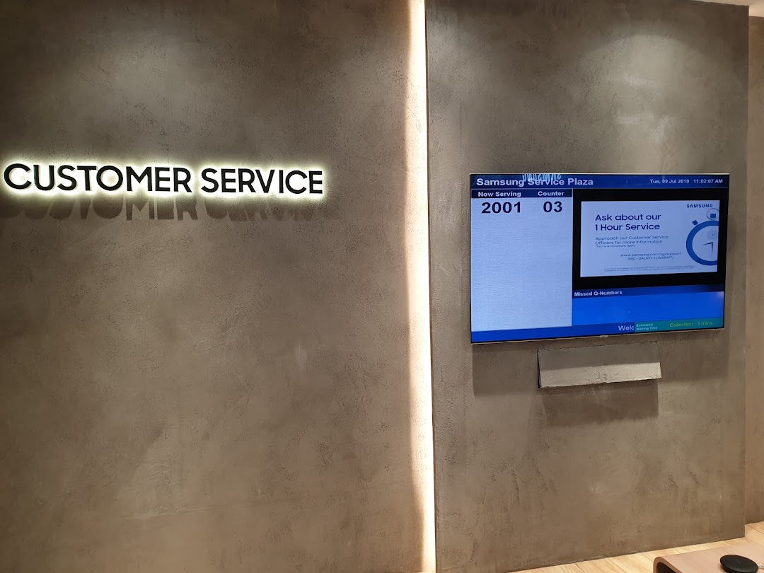 Interior of Samsung Service Centre with 'Customer Service' sign and queue display.