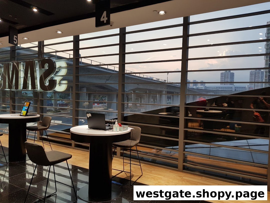 Interior of Samsung Service Centre featuring modern tables, chairs, and a large window view.