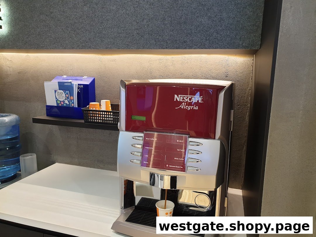 A Nescafe coffee machine and water dispenser in a modern service centre waiting area.