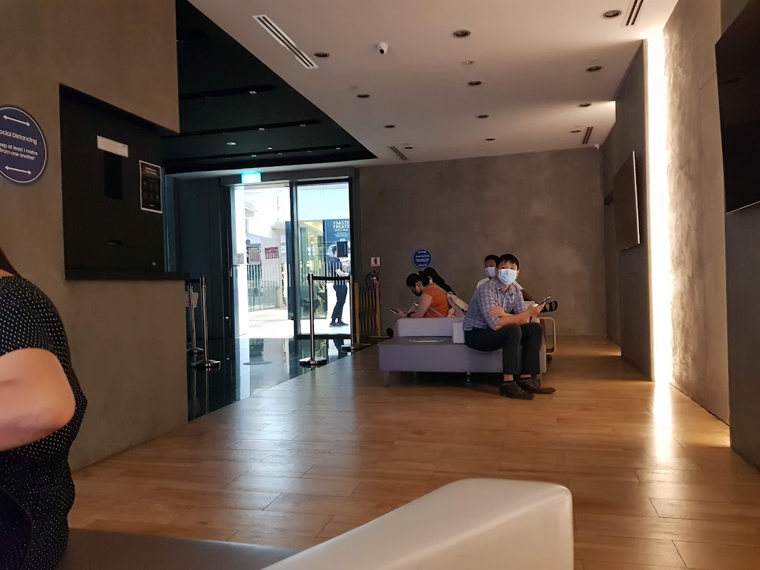Customers wait in a modern, well-lit lounge area at the Samsung Service Centre.
