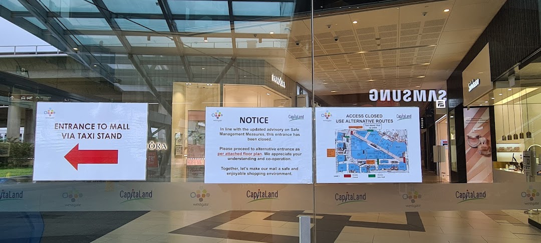 Glass mall entrance with temporary closure notices and a floor plan for alternative routes.