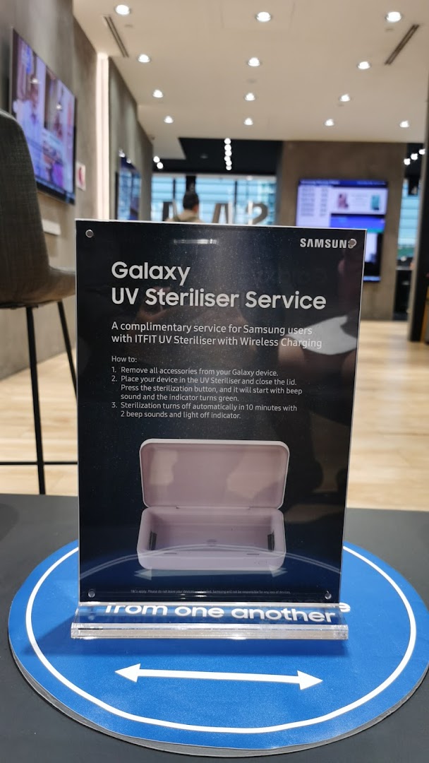 A Samsung Service Centre display sign detailing a complimentary UV steriliser service for Galaxy devices.