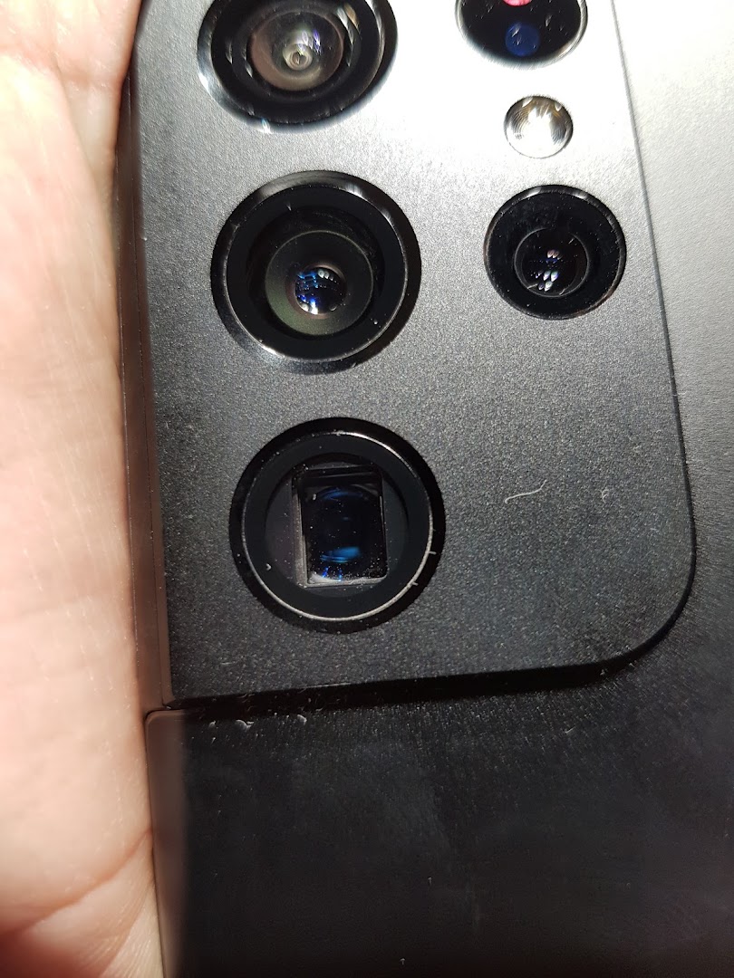 Close-up view of multiple camera lenses on the back of a modern Samsung smartphone.