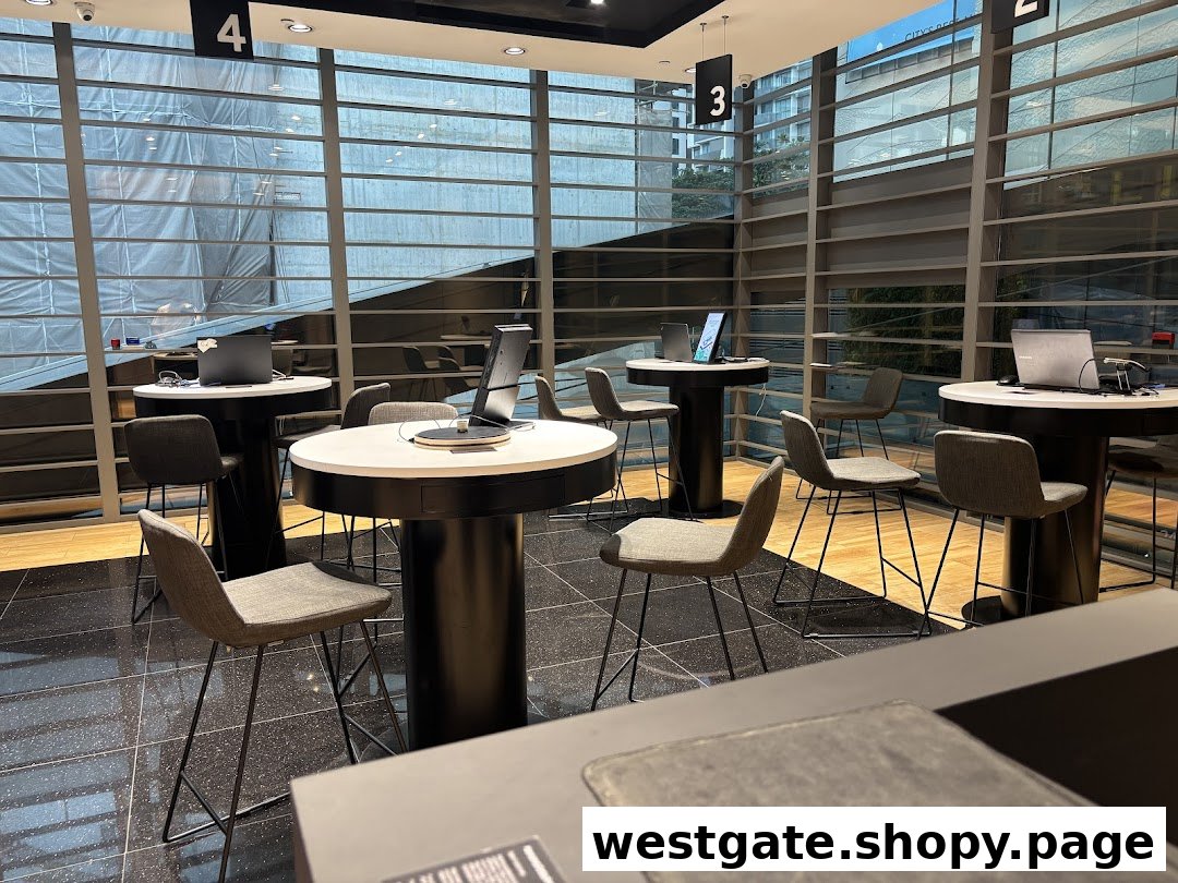 Interior view of a modern Samsung Service Centre with high-top tables, chairs, and laptops.