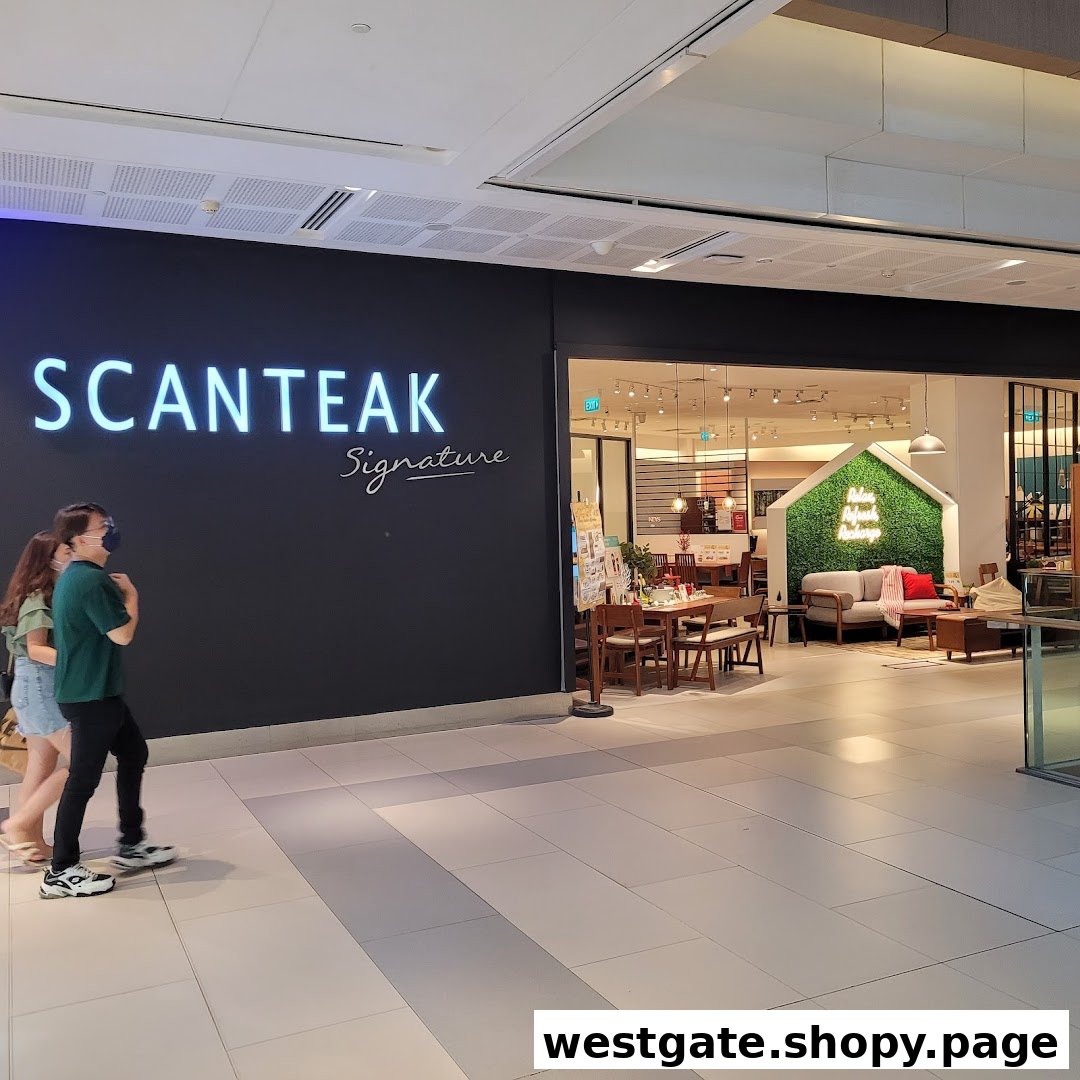 The illuminated entrance of Scanteak Signature, a furniture store, showcasing its interior display.