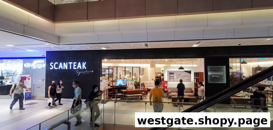 The shop front of Scanteak Signature, a furniture store, with its interior visible and people walking by.