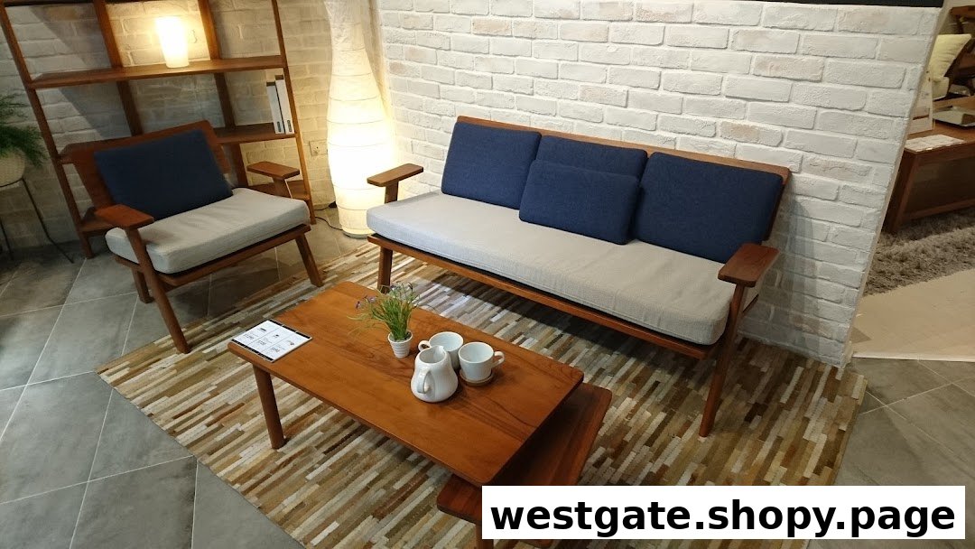 A stylish living room display featuring a wooden sofa, armchair, and coffee table on a patterned rug.