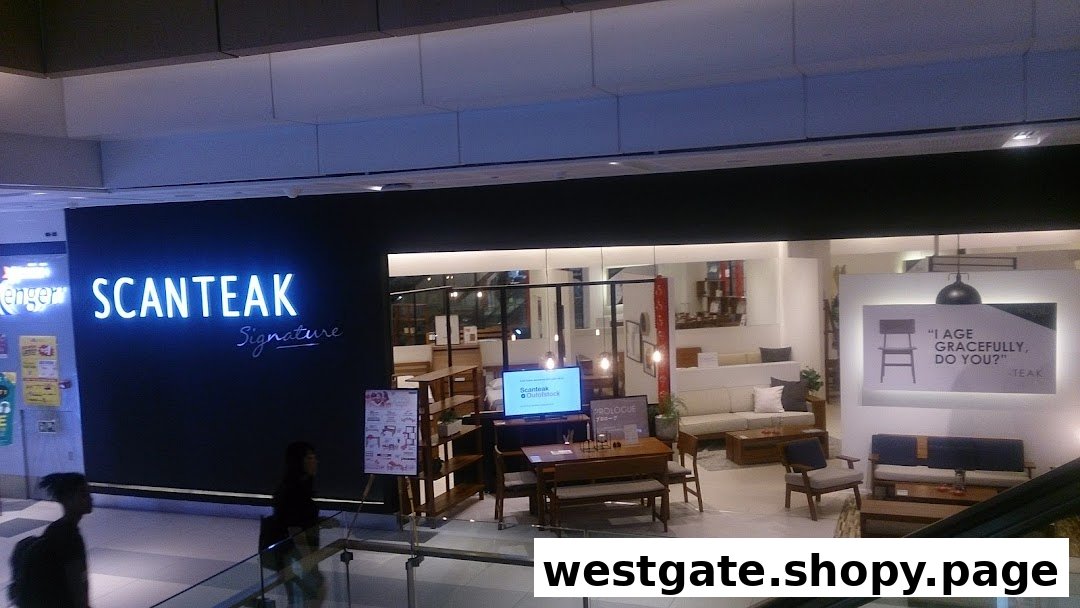 The Scanteak Signature shop front showcases modern teak furniture displays and a bright neon sign.