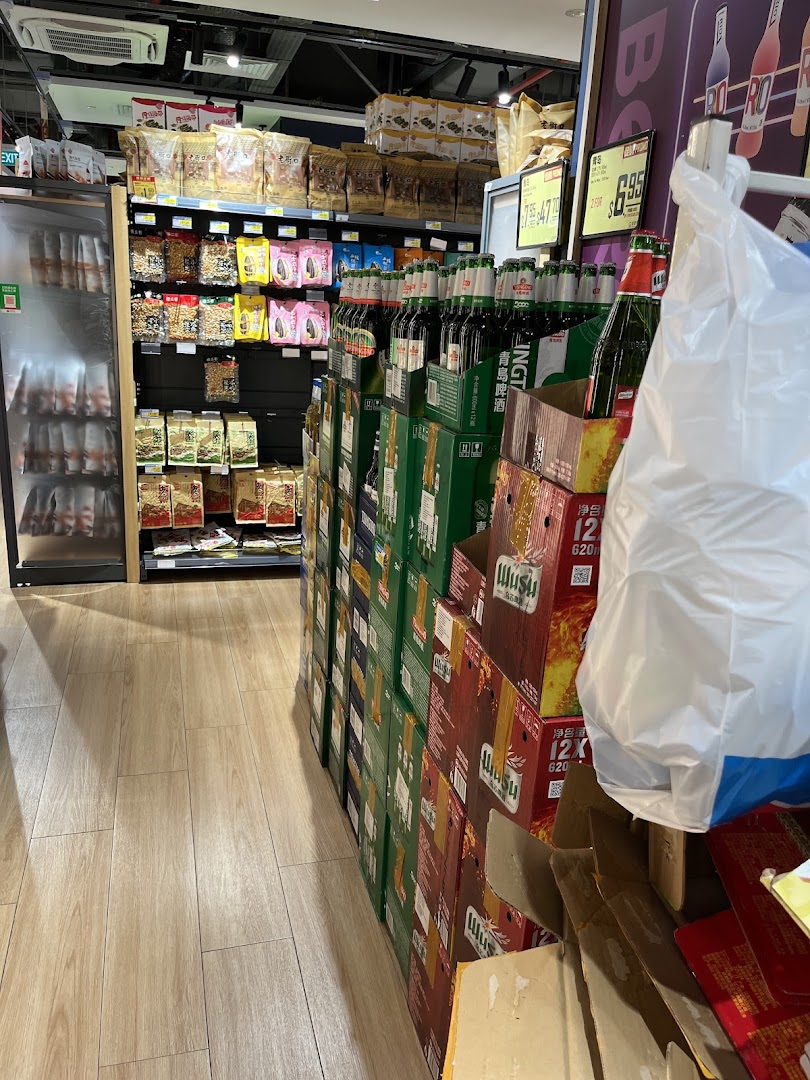 An aisle in Scarlett Supermarket featuring shelves of snacks and a large display of bottled beverages.