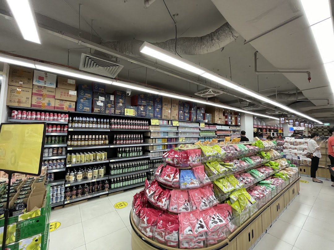 An interior view of Scarlett Supermarket, showcasing well-stocked aisles with diverse products and shoppers.