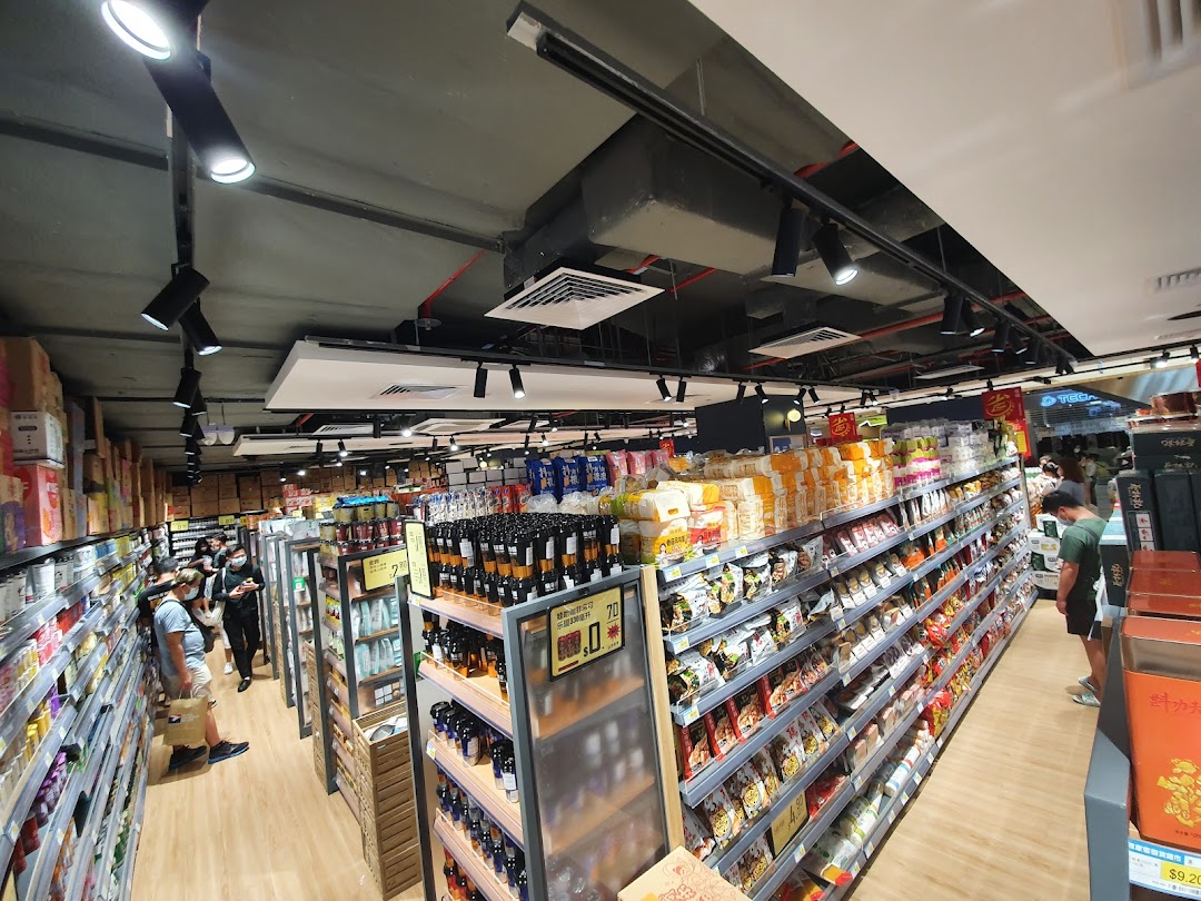 An interior view of Scarlett Supermarket, showcasing well-stocked aisles with a wide variety of products and shoppers.