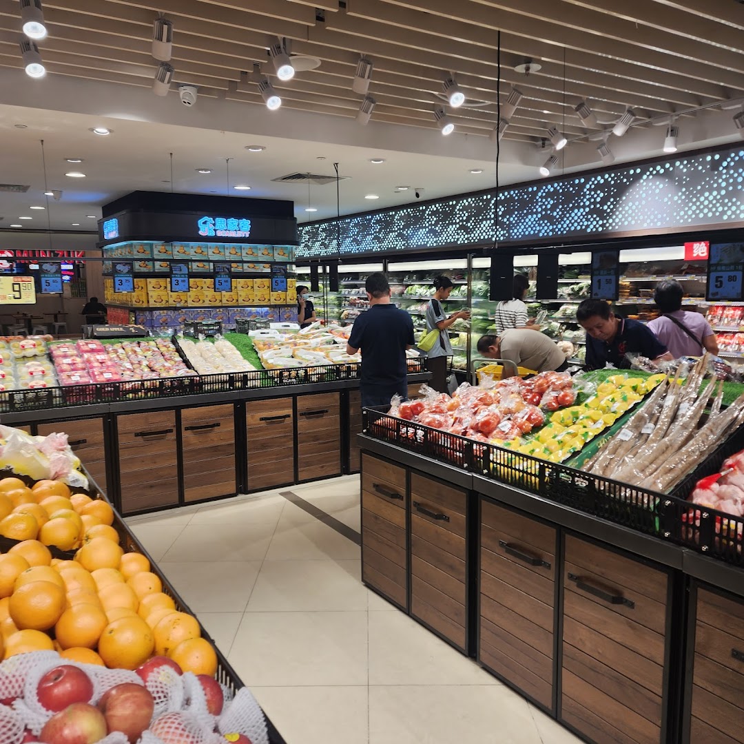 Customers browse fresh fruits and vegetables in the brightly lit produce section of Scarlett Supermarket.
