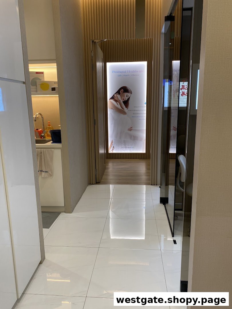 A bright, modern hallway with a 'Postnatal Healthcare' display leading to a treatment area.
