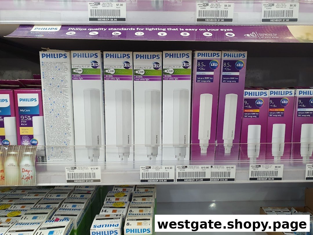 A shelf displaying various Philips light bulbs and lighting products, including LED and energy-saving options.