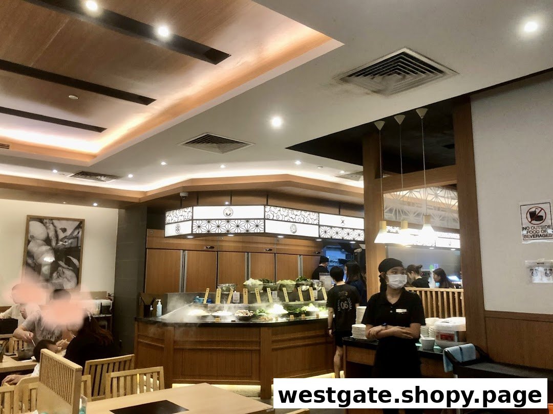 Interior view of Shabu Sai, showing a fresh buffet line, dining area, and staff.