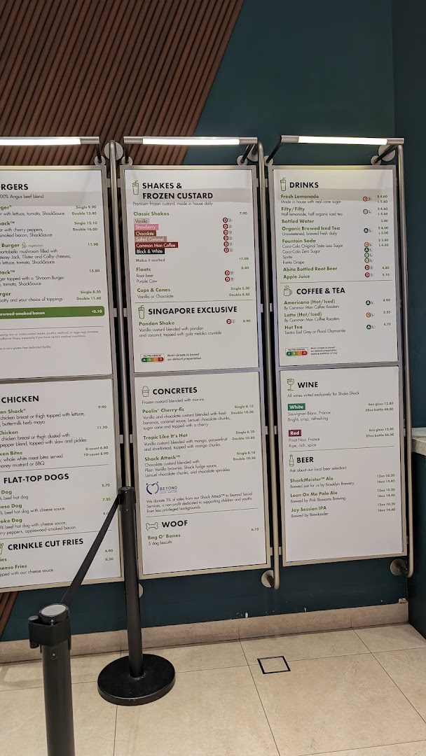 A clear view of Shake Shack's extensive menu boards displaying burgers, shakes, drinks, and more.